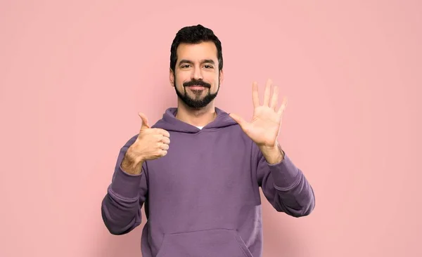 Handsome Man Sweatshirt Counting Six Fingers Isolated Pink Background — ストック写真