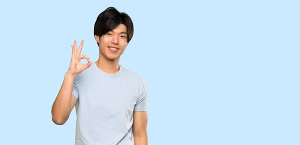 Asian Man Blue Shirt Showing Sign Fingers Isolated Blue Background — 스톡 사진