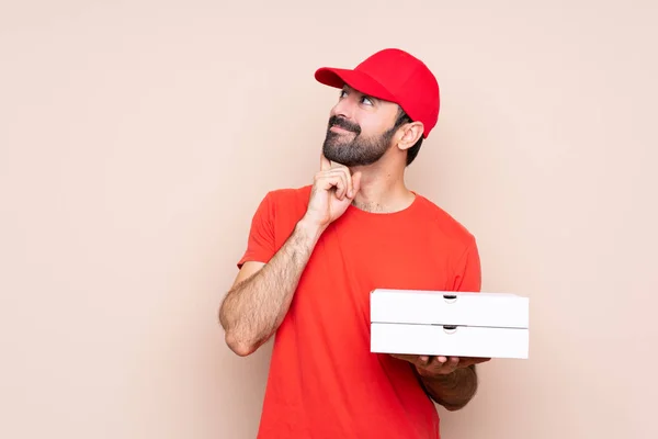 Young Man Holding Pizza Isolated Background Thinking Idea While Looking — 스톡 사진