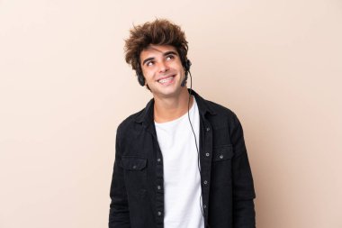 Tele pazarlamacı, izole bir geçmişi olan bir kulaklıkla çalışıyor. Gülüyor ve araştırıyor.