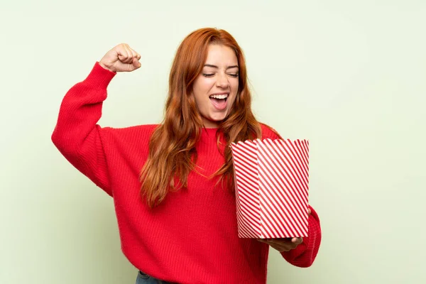 Nastolatek Rudowłosy Dziewczyna Sweter Białym Tle Zielone Trzymając Miskę Popcorns — Zdjęcie stockowe
