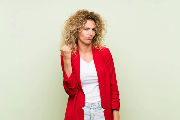 Young Blonde Woman Curly Hair Isolated Green Background Angry Gesture — 스톡 사진