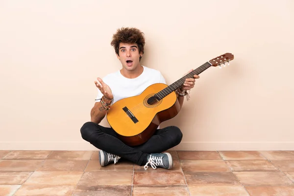 Joven Hombre Caucásico Con Una Guitarra Sentada Suelo Con Expresión — Foto de Stock
