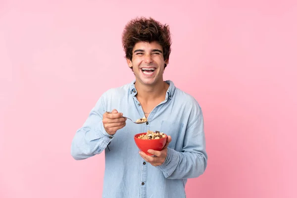 Young Caucasian Man Isolated Pink Background Holding Bowl Cereals — Stockfoto