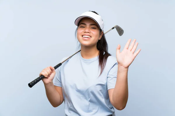 Young Golfer Asian Girl Isolated Blue Background Saluting Hand Happy — Stock Photo, Image
