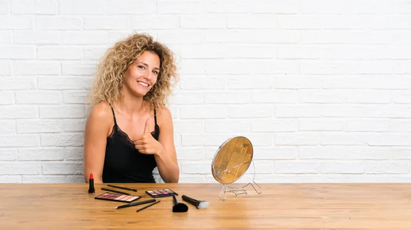 Young Woman Lots Makeup Brush Table Giving Thumbs Gesture — 스톡 사진