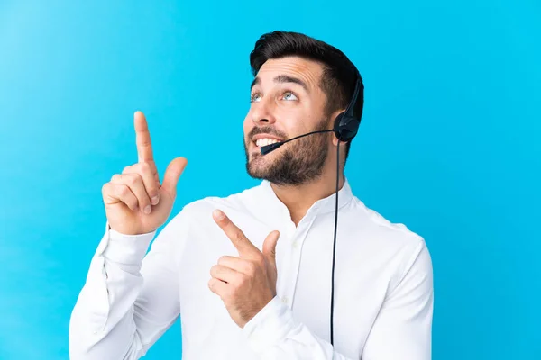 Hombre Telemarketer Trabajando Con Auricular Sobre Fondo Azul Aislado Apuntando — Foto de Stock