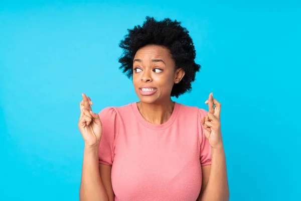 African American Woman Isolated Blue Background Fingers Crossing — 스톡 사진
