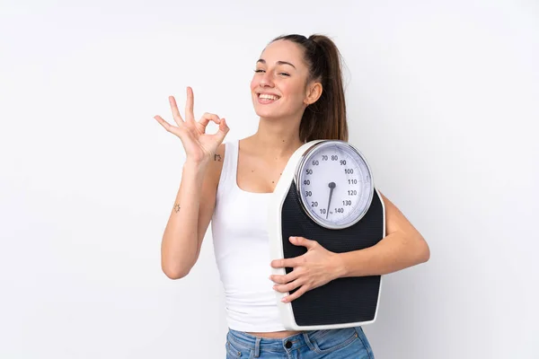 Young Brunette Woman Isolated White Background Holding Weighing Machine Doing — Stock Photo, Image