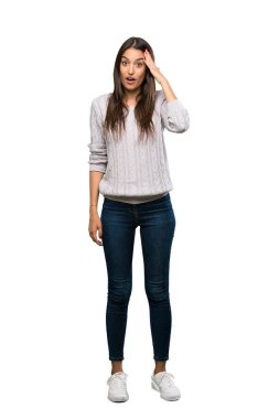 A full-length shot of a Young hispanic brunette woman has just realized something and has intending the solution over isolated white background