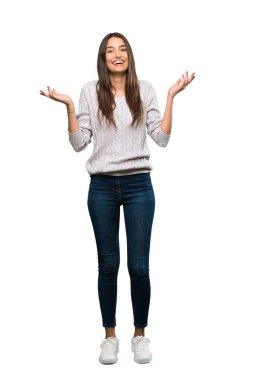 A full-length shot of a Young hispanic brunette woman smiling a lot over isolated white background