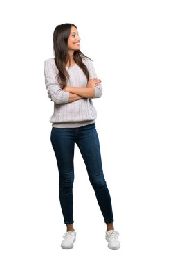 A full-length shot of a Young hispanic brunette woman happy and smiling over isolated white background