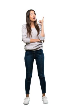 A full-length shot of a Young hispanic brunette woman thinking an idea pointing the finger up over isolated white background