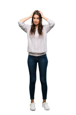 A full-length shot of a Young hispanic brunette woman frustrated and takes hands on head over isolated white background