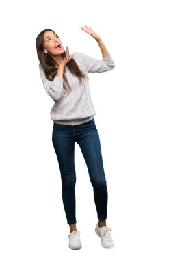 A full-length shot of a Young hispanic brunette woman nervous and scared over isolated white background