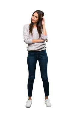 A full-length shot of a Young hispanic brunette woman having doubts over isolated white background