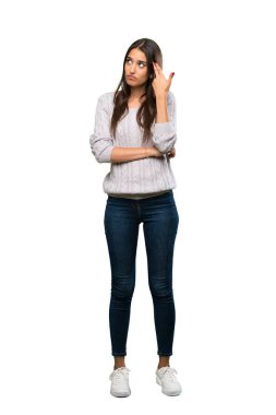 A full-length shot of a Young hispanic brunette woman with problems making suicide gesture over isolated white background