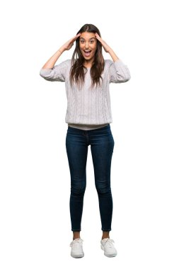 A full-length shot of a Young hispanic brunette woman with surprise expression over isolated white background