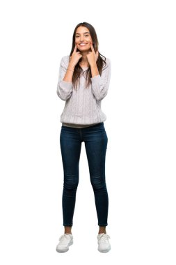 A full-length shot of a Young hispanic brunette woman smiling with a happy and pleasant expression over isolated white background