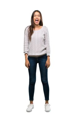 A full-length shot of a Young hispanic brunette woman shouting to the front with mouth wide open over isolated white background