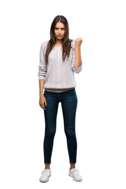 A full-length shot of a Young hispanic brunette woman with angry gesture over isolated white background