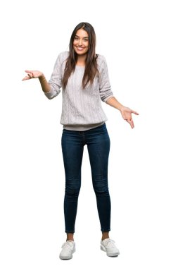 A full-length shot of a Young hispanic brunette woman smiling over isolated white background