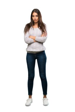 A full-length shot of a Young hispanic brunette woman feeling upset over isolated white background