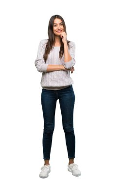 A full-length shot of a Young hispanic brunette woman smiling over isolated white background