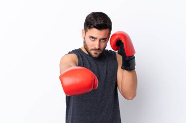 Sakallı, yakışıklı, soyutlanmış beyaz bir geçmişi ve boks eldivenleri olan genç bir adam.