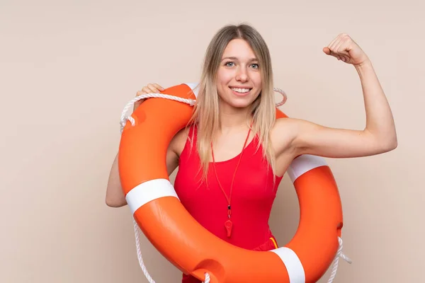 Lifeguard woman making strong gesture over isolated background