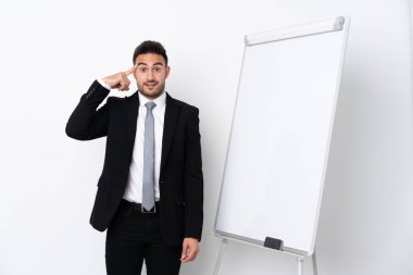 Young man giving a presentation on white board and intending to realizes the solution