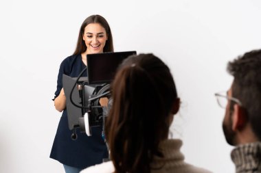 Gazeteci kadın mikrofon tutuyor ve haberleri beyaz arka planda izole ediyor.