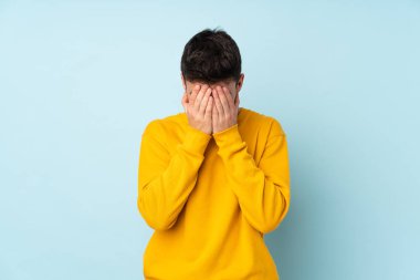 Mor arka planda soluk benizli, beyaz, yakışıklı, yorgun ve hasta bir yüz ifadesi var.