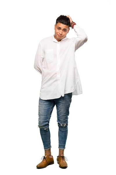 A full-length shot of a Young man with an expression of frustration and not understanding over isolated white background