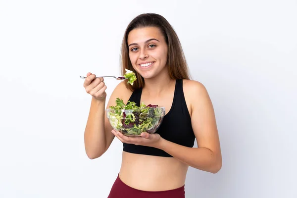 Adolescente chica con ensalada sobre fondo aislado — Foto de Stock