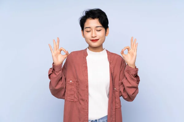 Joven Asiática Chica Sobre Aislado Azul Fondo Zen Pose —  Fotos de Stock