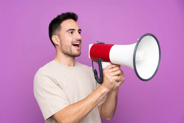 Young Handsome Man Isolated Purple Background Shouting Megaphone — 스톡 사진