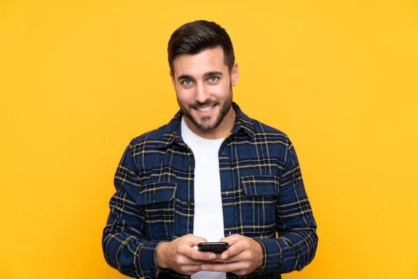 Young Handsome Man Beard Isolated Yellow Background Sending Message Mobile — Stock Photo, Image