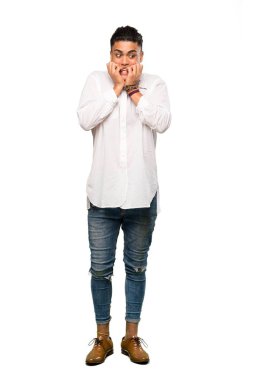 Gergin ve korkmuş genç bir adamın, izole edilmiş beyaz arka planda ellerini ağıza koyduğu uzun bir çekim.