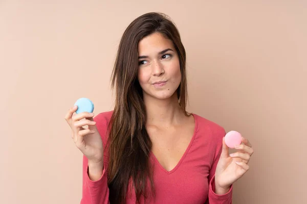 Teenager Girl Isolated Background Holding Colorful French Macarons Thinking — Stock Photo, Image