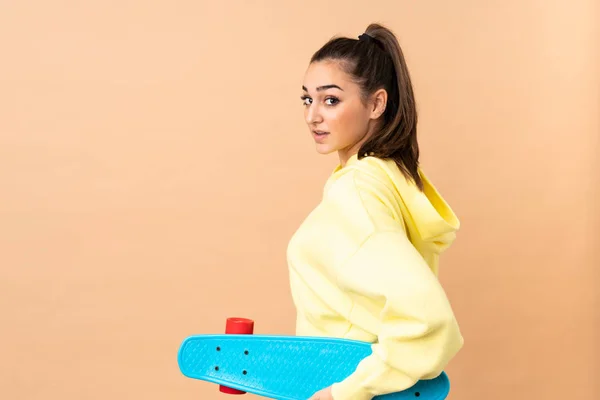 Jonge Kaukasische Vrouw Geïsoleerd Roze Achtergrond Met Een Skate — Stockfoto