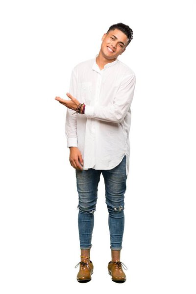 A full-length shot of a Young man presenting an idea while looking smiling towards over isolated white background