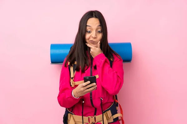 Joven Montañista Con Una Gran Mochila Sobre Fondo Rosa Aislado —  Fotos de Stock