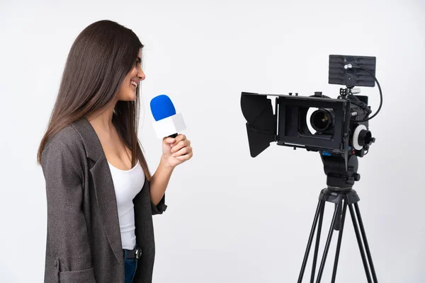 Reporter woman holding a microphone and reporting news over isol — Stock Photo, Image