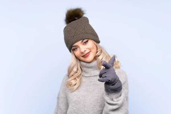 Junges Teenager Mädchen Mit Wintermütze Über Isoliertem Blauem Hintergrund Zeigt — Stockfoto