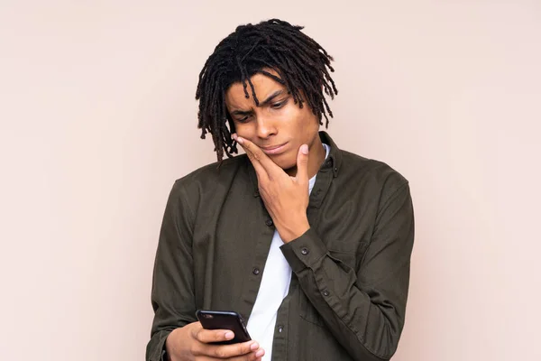 stock image Young African American man over isolated background thinking and sending a message