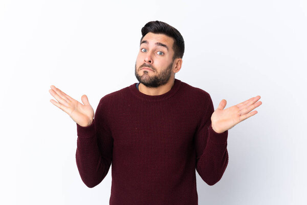 Young handsome man with beard over isolated white background making doubts gesture