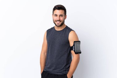 Genç, yakışıklı, sakallı, soyutlanmış beyaz bir geçmişi olan mutlu ve gülümseyen bir adam.