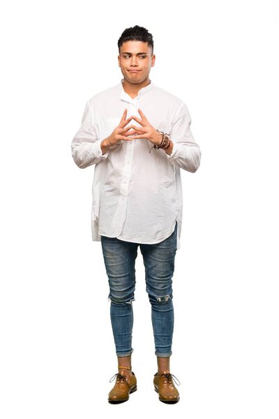 A full-length shot of a Young man scheming something over isolated white background