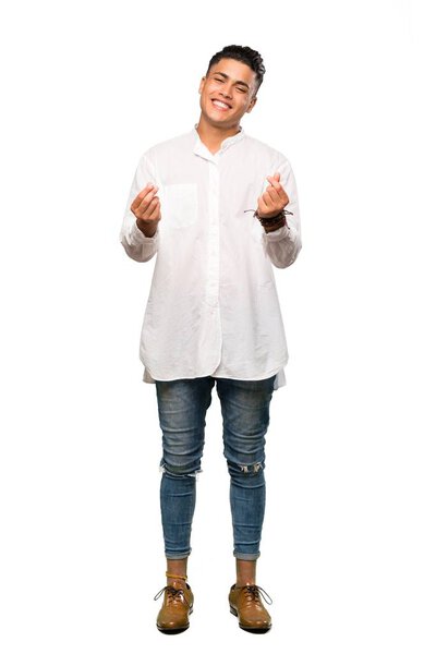A full-length shot of a Young man making money gesture over isolated white background